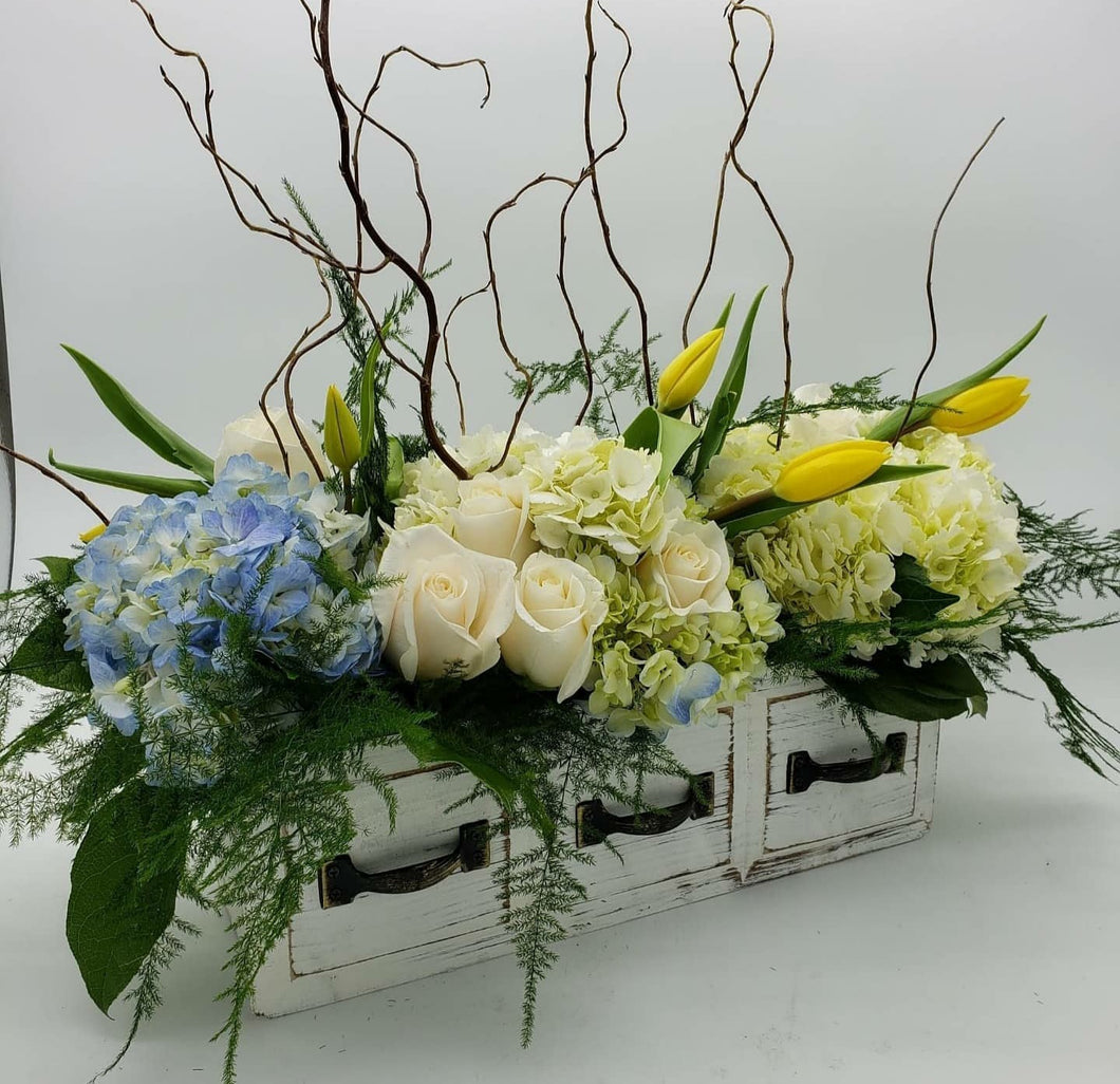 Flowers Arranged in a wooden case